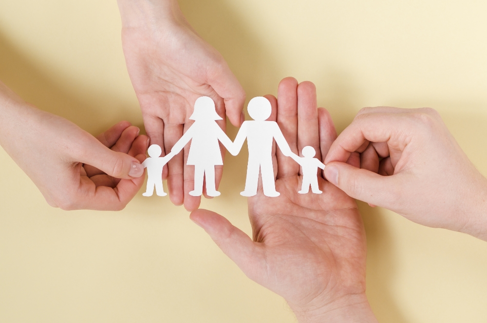 Family holding hands — insurance and care at Selgate